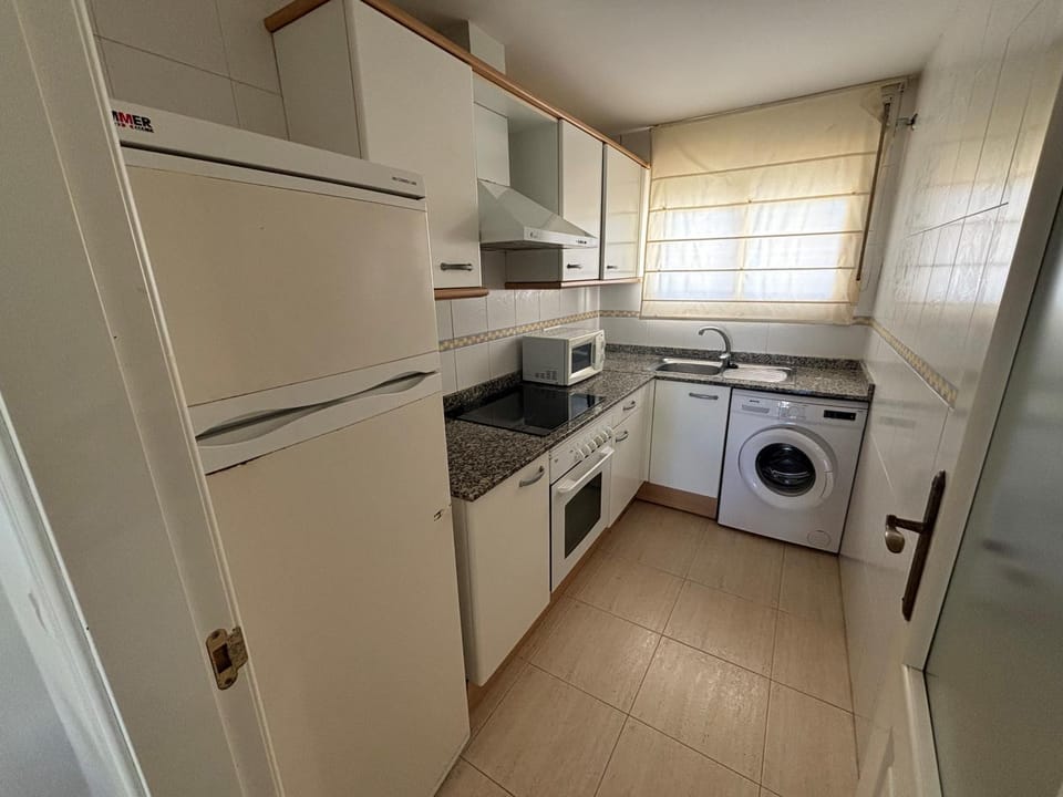 Kitchen or kitchenette, oven, stove, washing machine