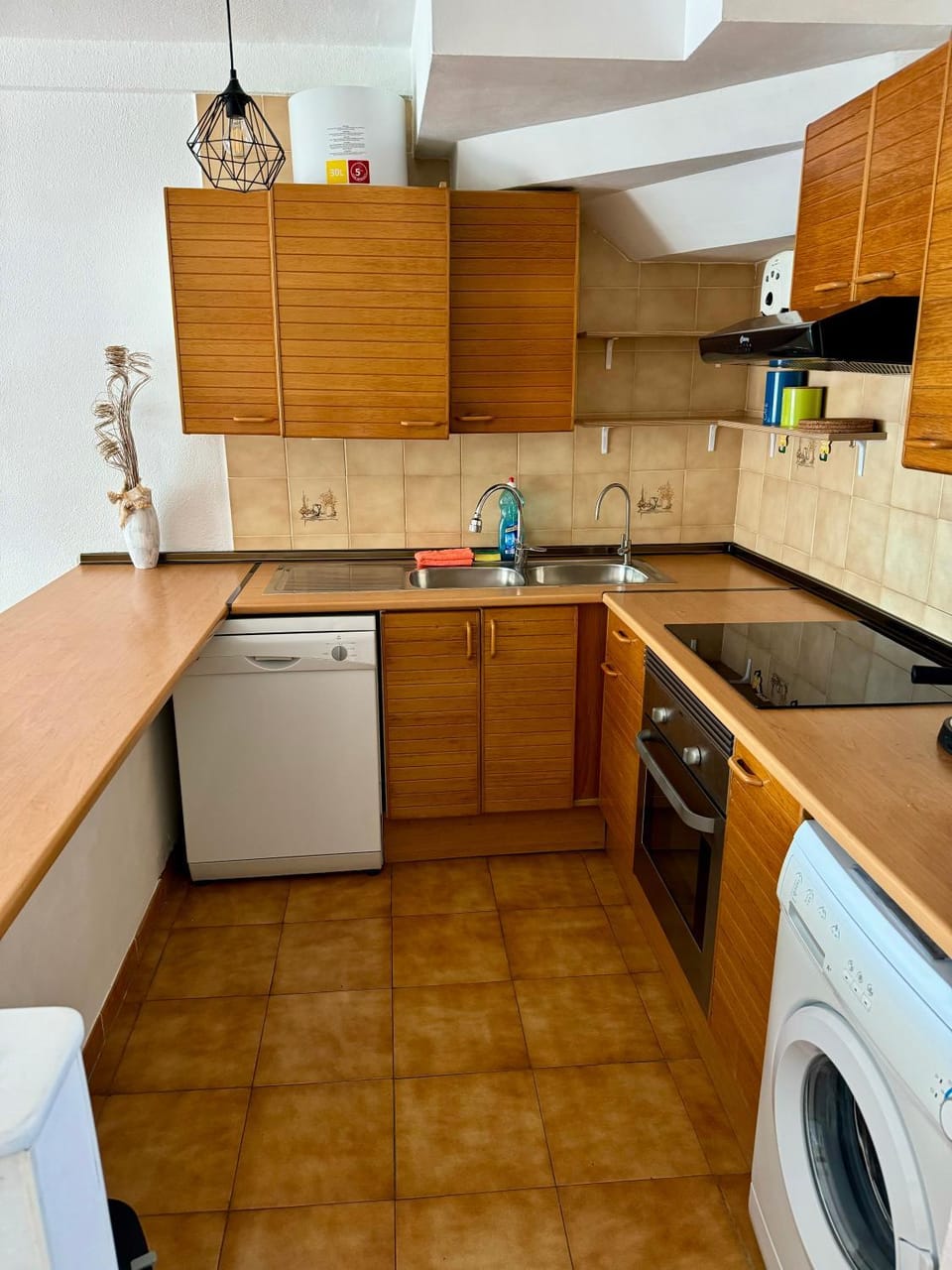 Kitchen or kitchenette, dishwasher, oven, stove, toaster, washing machine