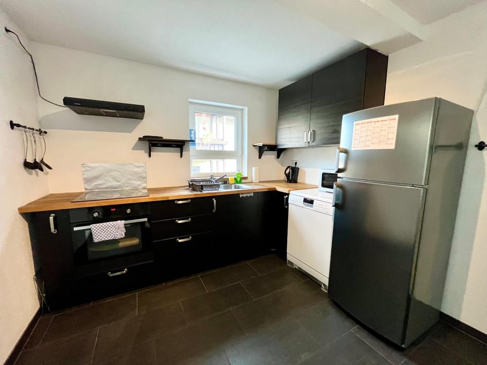 Kitchen or kitchenette, dishwasher, oven, stove