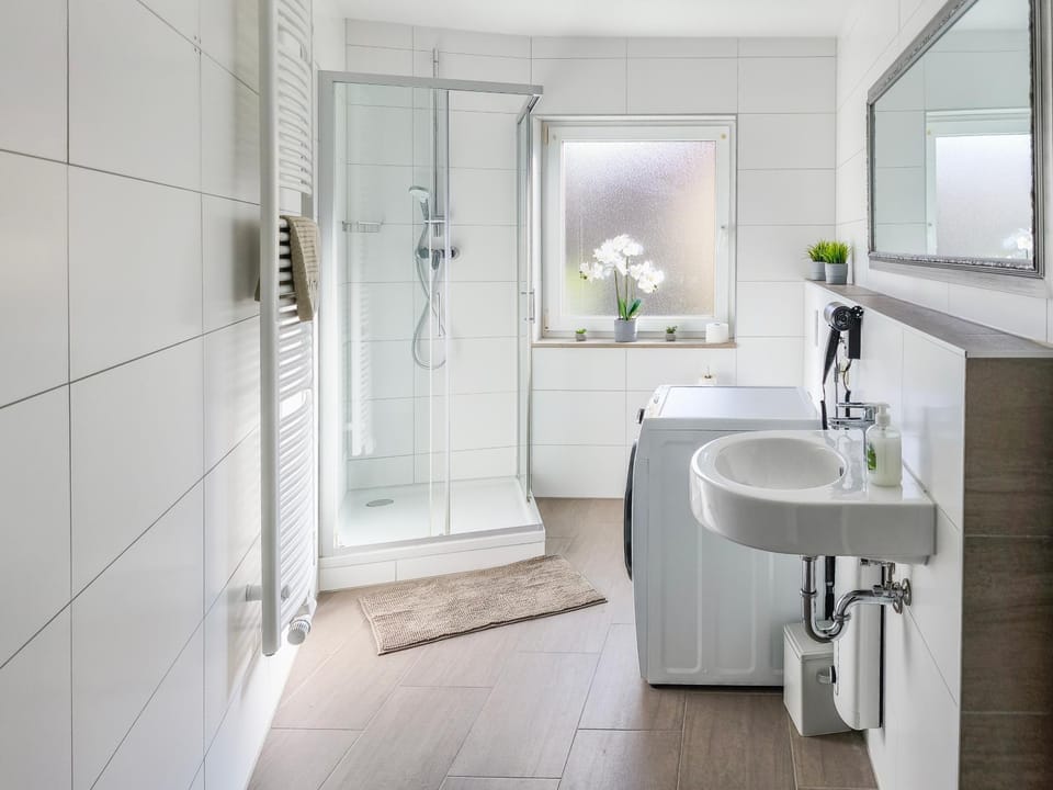 Shower, Toilet, Bathroom, hair dryier, towels, washing machine, dryer