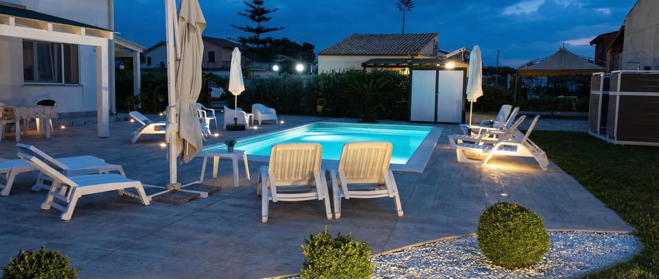Property building, Patio, Night, Natural landscape, Pool view, Swimming pool, Swimming pool, sunbed