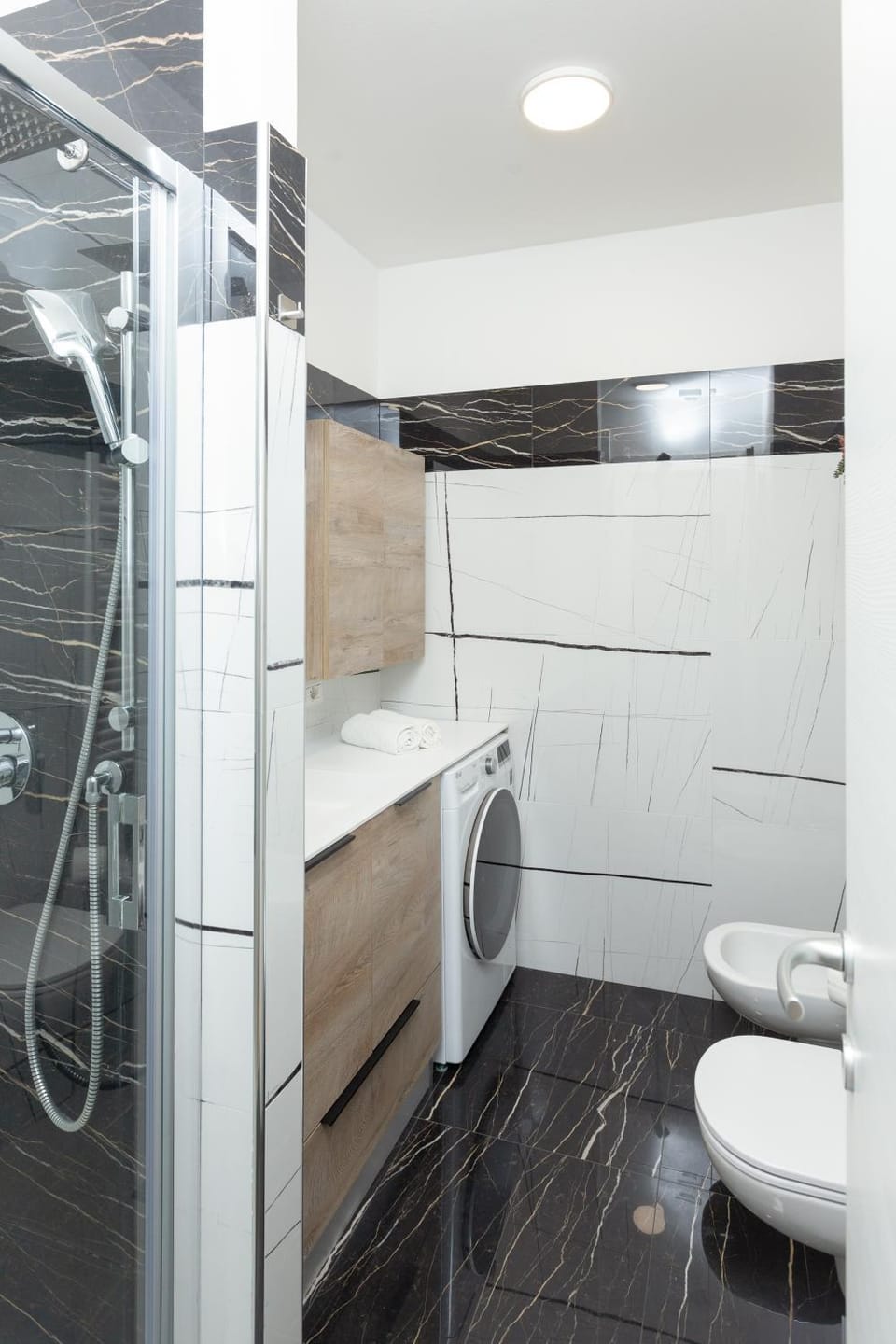 Shower, Toilet, Bathroom, bidet, towels, washing machine, dryer