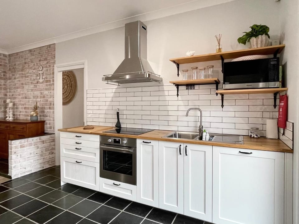 Kitchen or kitchenette, dishwasher, oven, stove