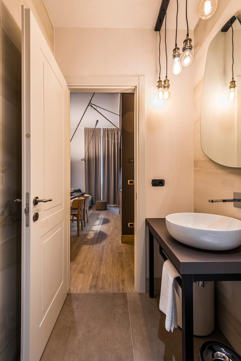 Eco Chic room with sofa bed and kitchen by Design Club Collection Apartment in Bologna