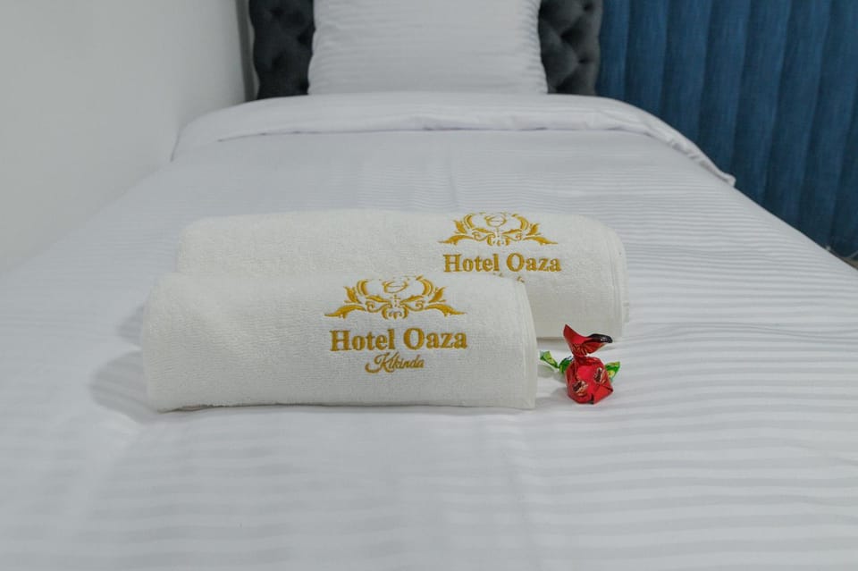 Bed, Property logo or sign, towels