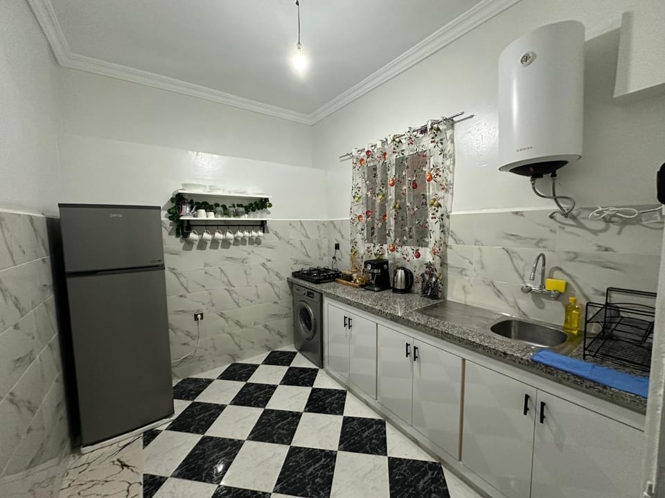Kitchen or kitchenette, dishwasher, oven, stove