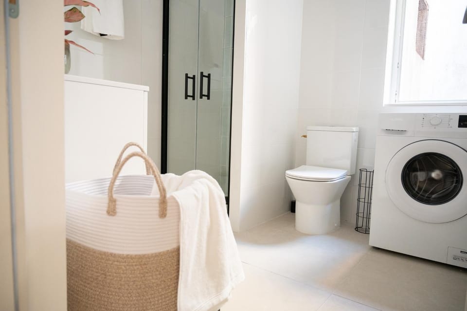 Toilet, Bathroom, hair dryier, heating, towels, washing machine