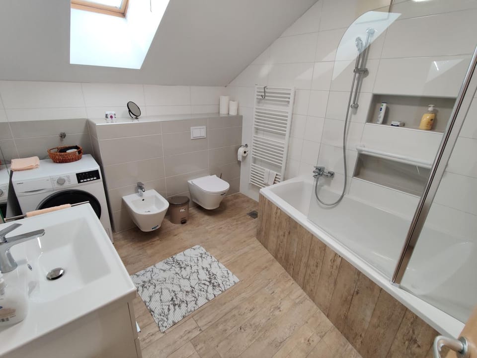 Toilet, Bathroom, Bath, bidet, hair dryier, towels, washing machine, dryer