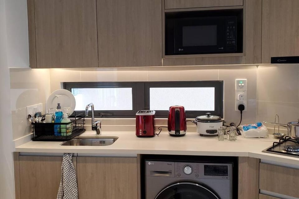 Kitchen or kitchenette, microwave, stove, toaster, washing machine, dryer