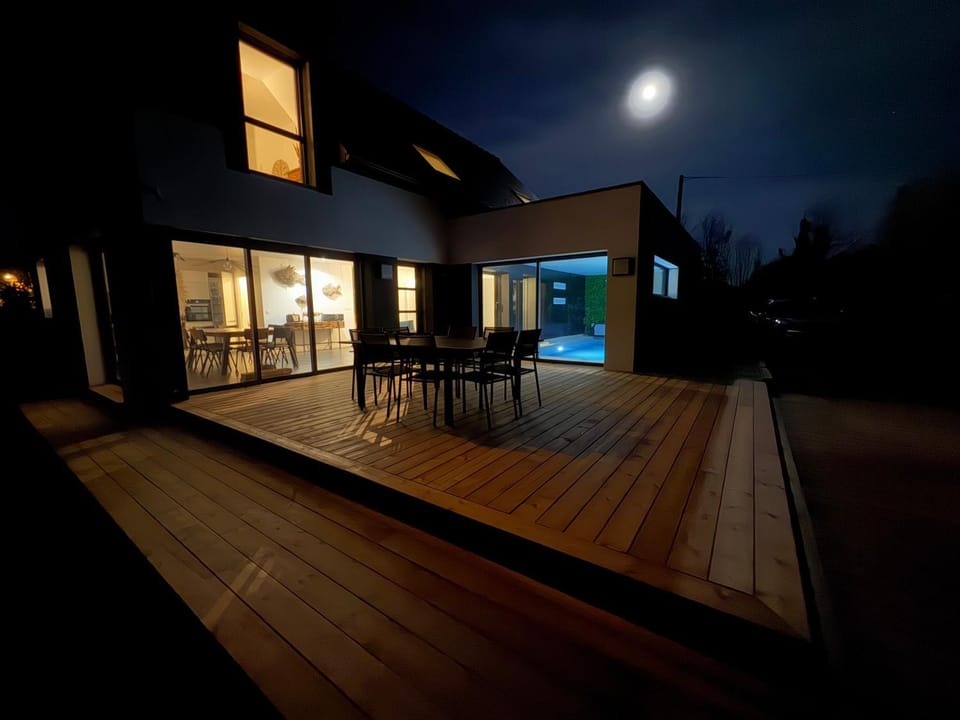 Property building, Patio, Night, Dining area, Pool view, Swimming pool