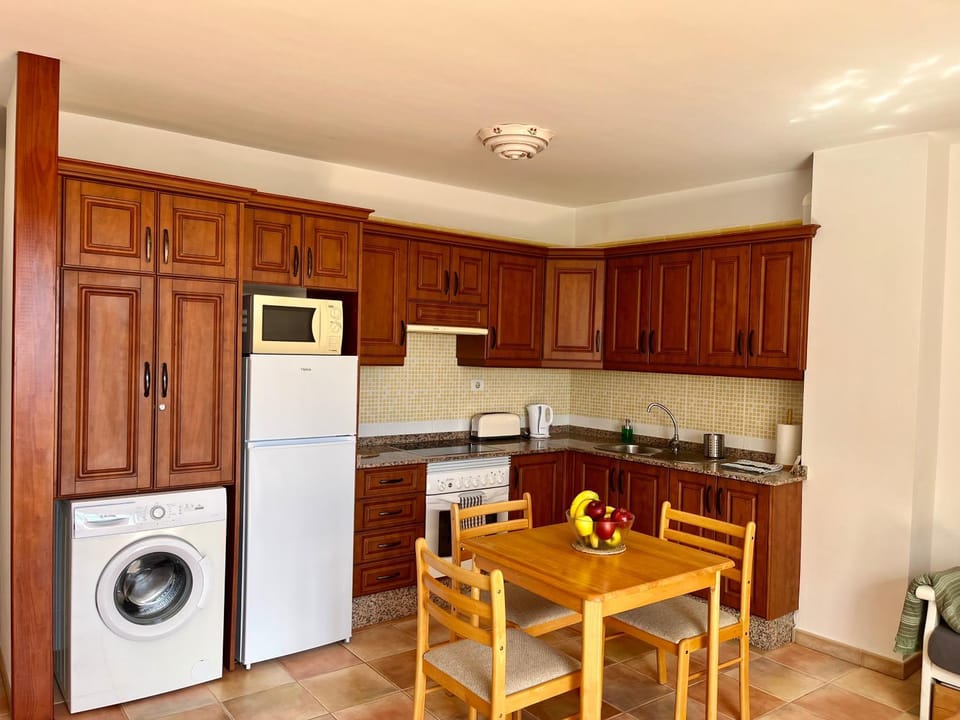 Kitchen or kitchenette, Seating area, Dining area, oven, stove, toaster, washing machine