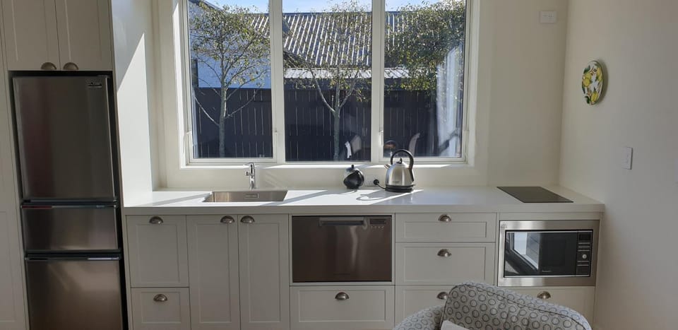 Kitchen or kitchenette, dishwasher, oven, stove