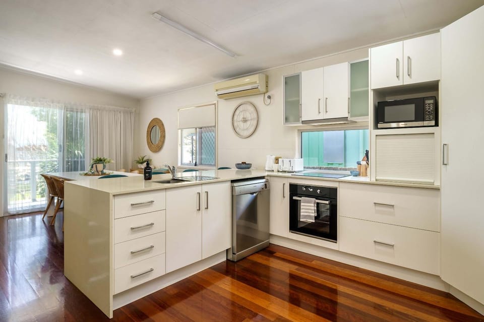 Kitchen or kitchenette, dishwasher, oven, stove, toaster, air conditioner
