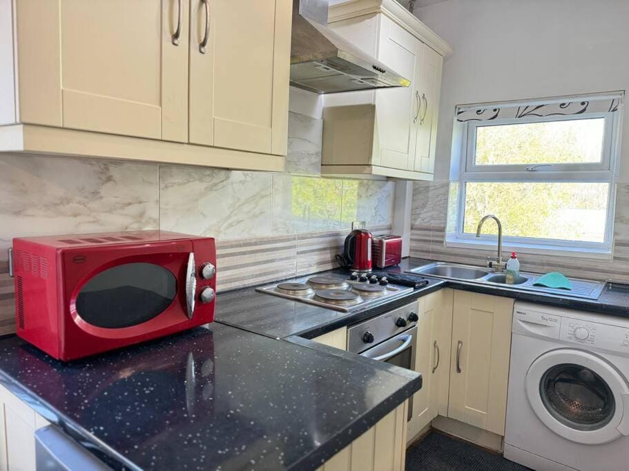 Kitchen or kitchenette, stove, toaster, washing machine