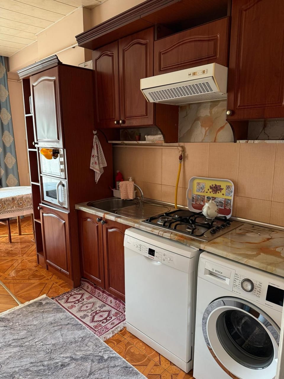 Kitchen or kitchenette, dishwasher, oven, stove, washing machine