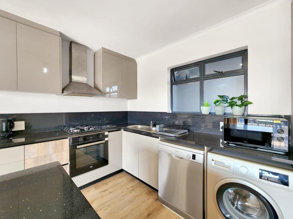 Kitchen or kitchenette, dishwasher, microwave, oven, stove