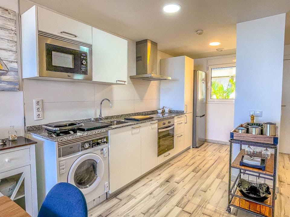 Kitchen or kitchenette, stove, toaster, washing machine