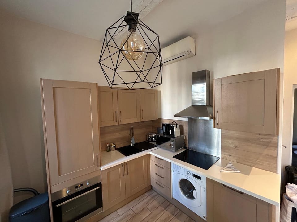 Kitchen or kitchenette, dishwasher, oven, stove, toaster, washing machine