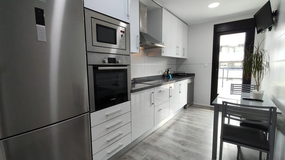 Kitchen or kitchenette, dishwasher, oven, stove, toaster