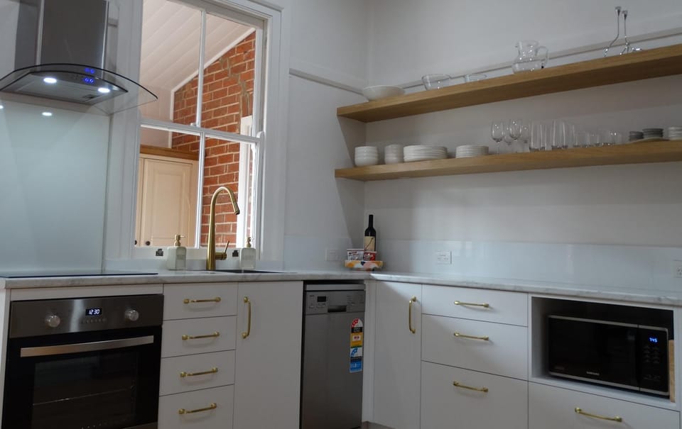 Kitchen or kitchenette, dishwasher, microwave, oven, stove