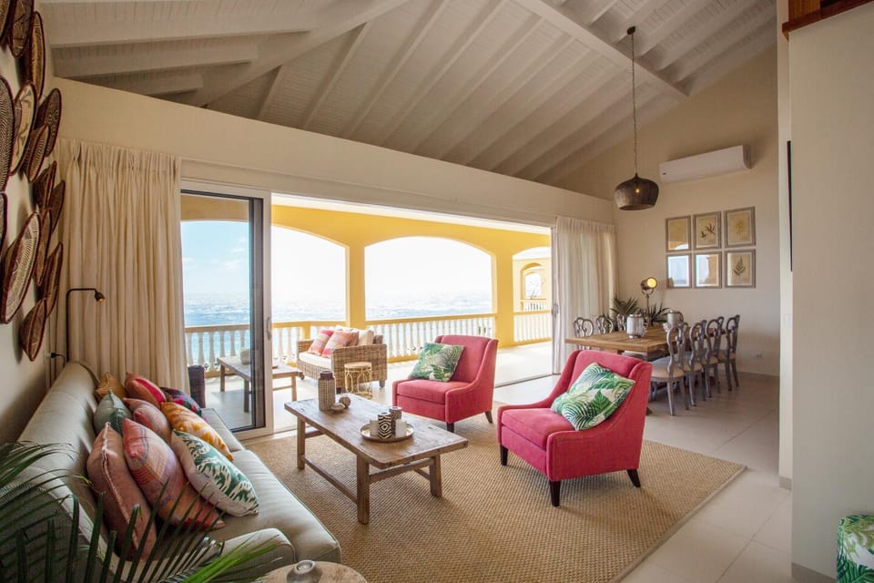 View (from property/room), Living room, Seating area, Dining area, Sea view