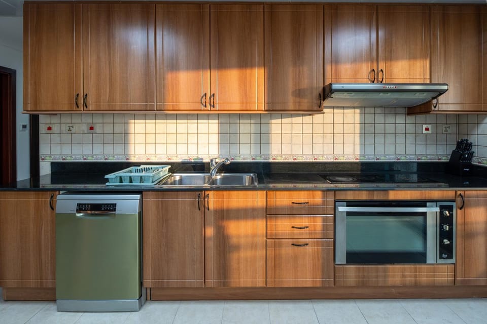 Kitchen or kitchenette, dishwasher, oven, stove