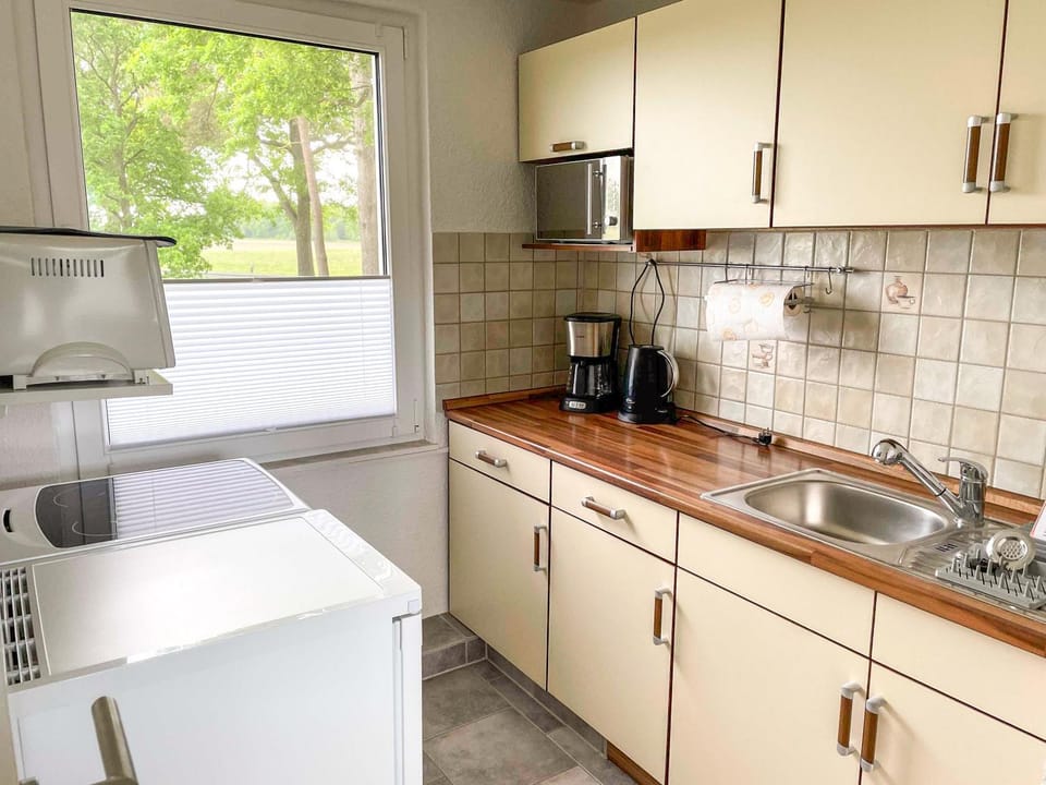 Kitchen or kitchenette, microwave, stove, toaster