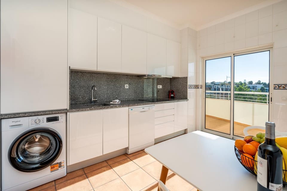Kitchen or kitchenette, dishwasher, oven, stove, washing machine