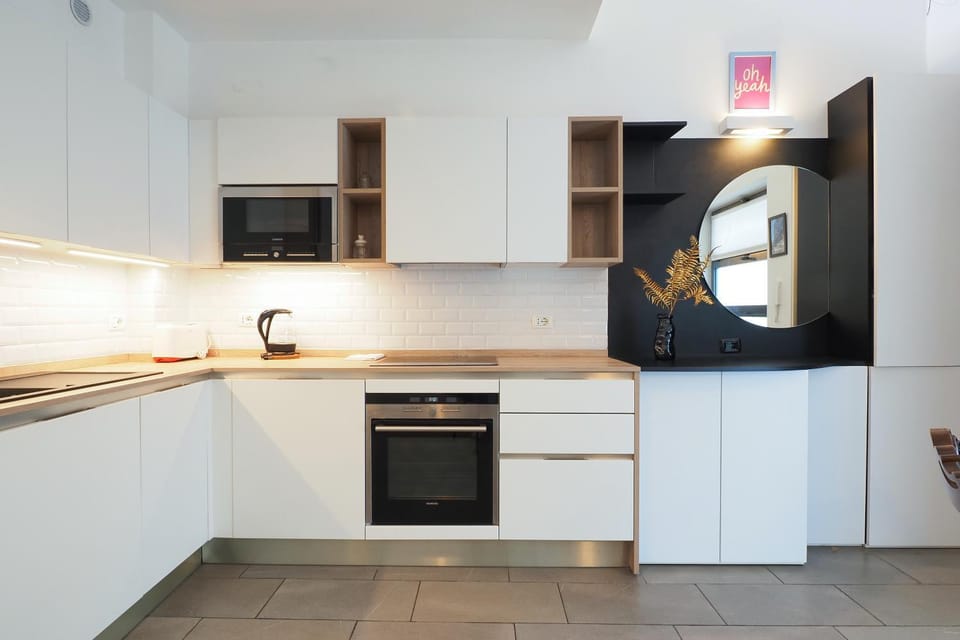 Kitchen or kitchenette, dishwasher, oven, stove