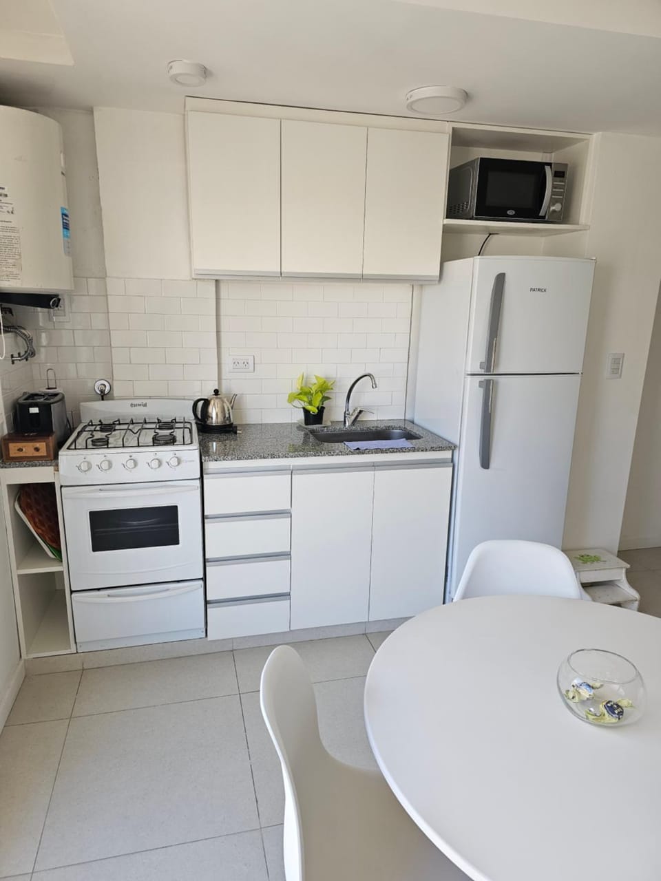 Kitchen or kitchenette, microwave, oven, storage, stove, toaster