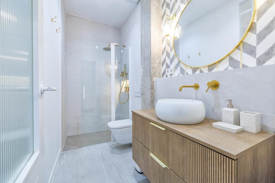 Shower, Toilet, Bathroom, hair dryier, towels, washing machine