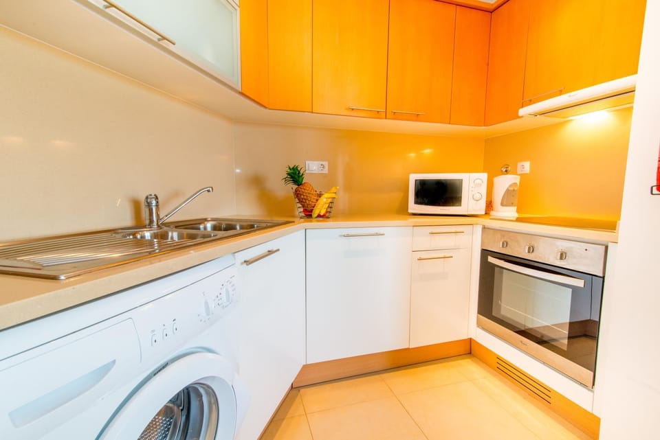 Kitchen or kitchenette, dishwasher, oven, stove, toaster, washing machine