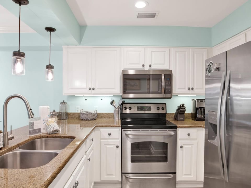 Kitchen or kitchenette, microwave, oven, stove, air conditioner
