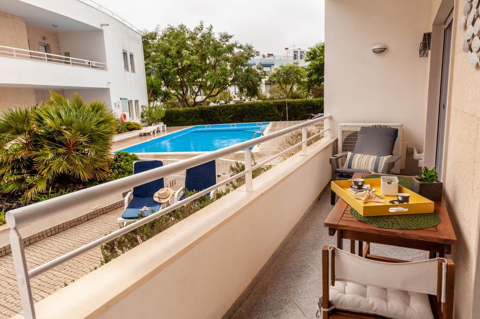 Property building, Patio, Day, View (from property/room), Balcony/Terrace, Balcony/Terrace, Seating area, Pool view, Swimming pool, sunbed