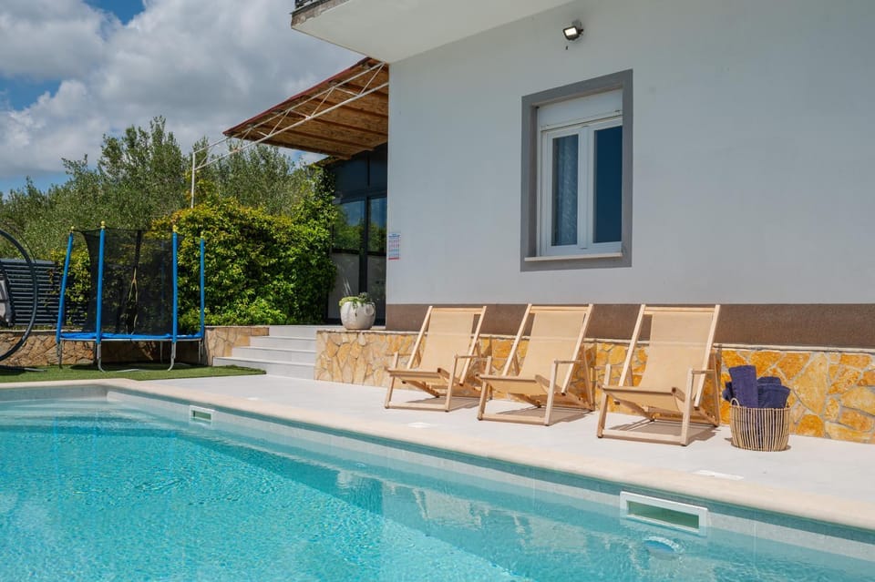Property building, Patio, Pool view, Swimming pool, sunbed
