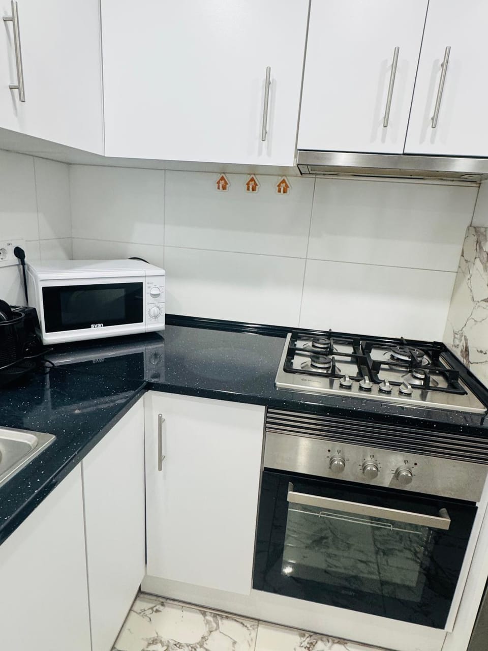 Kitchen or kitchenette, microwave, oven, stove