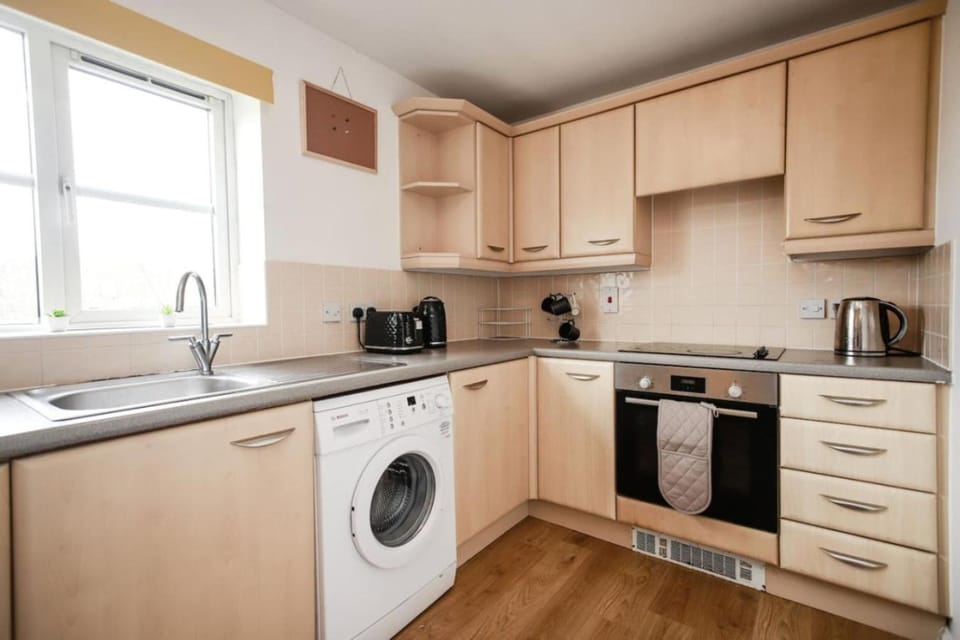 Kitchen or kitchenette, oven, stove, toaster, washing machine