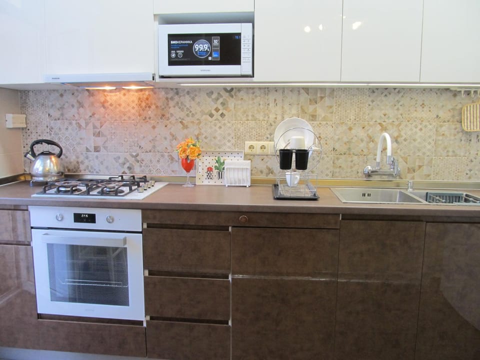 Kitchen or kitchenette, dishwasher, microwave, oven, stove