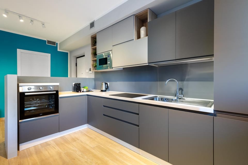 Kitchen or kitchenette, dishwasher, oven, stove