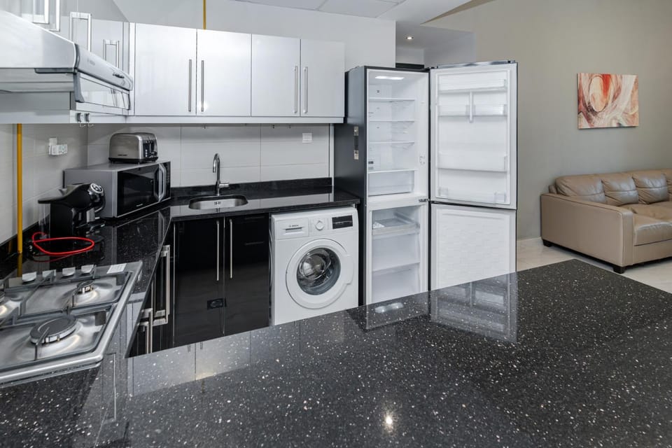 Kitchen or kitchenette, oven, stove, washing machine