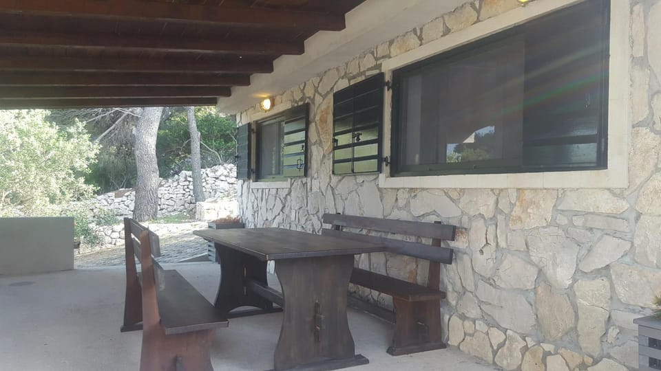 Stone house with a boat Country House in Tisno