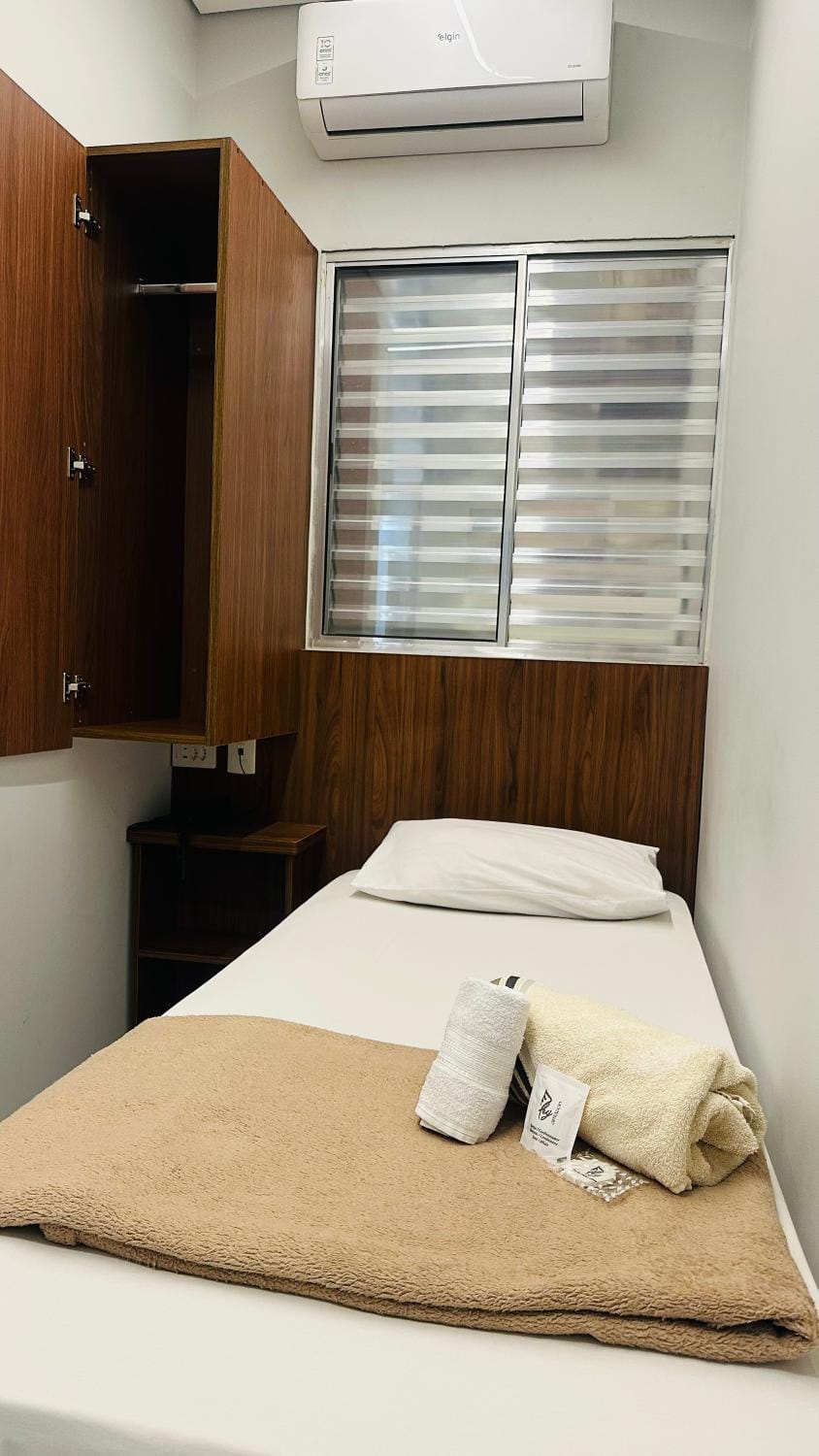 Bed, towels, wardrobe, air conditioner