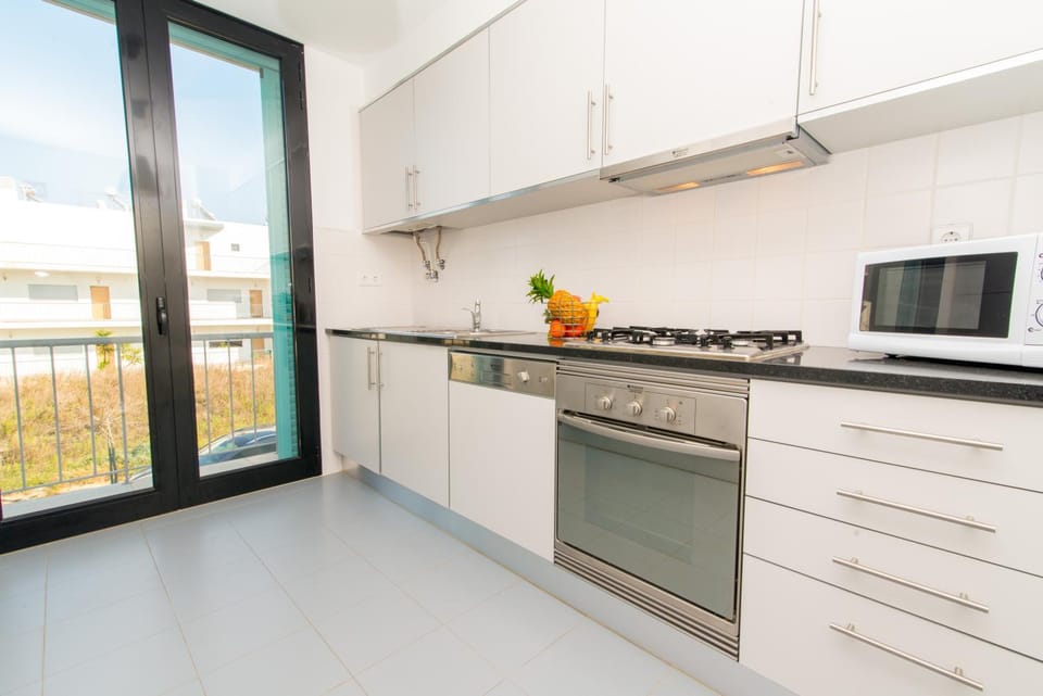 Kitchen or kitchenette, dishwasher, oven, stove