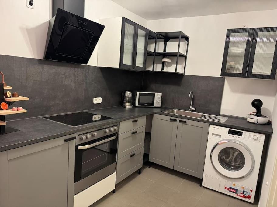 Kitchen or kitchenette, oven, stove, toaster, washing machine