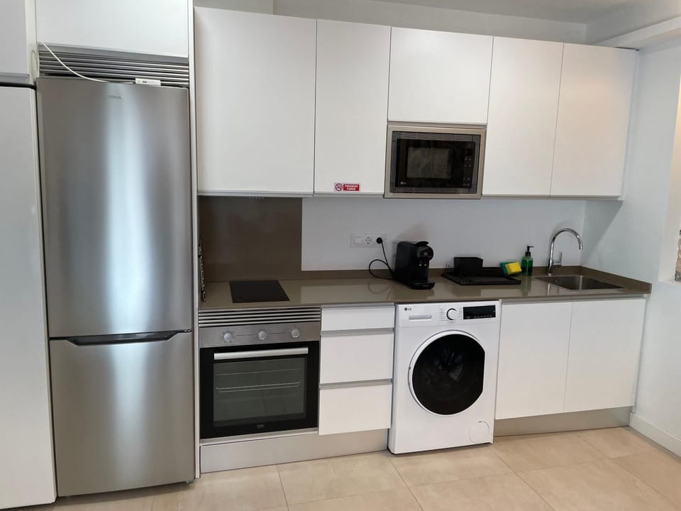 Kitchen or kitchenette, dishwasher, oven, stove, toaster, washing machine