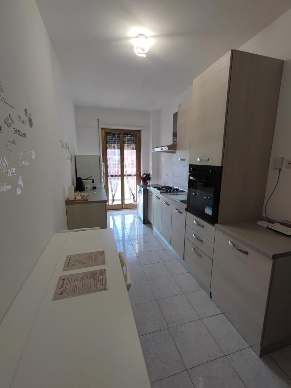 Kitchen or kitchenette, dishwasher, oven, stove