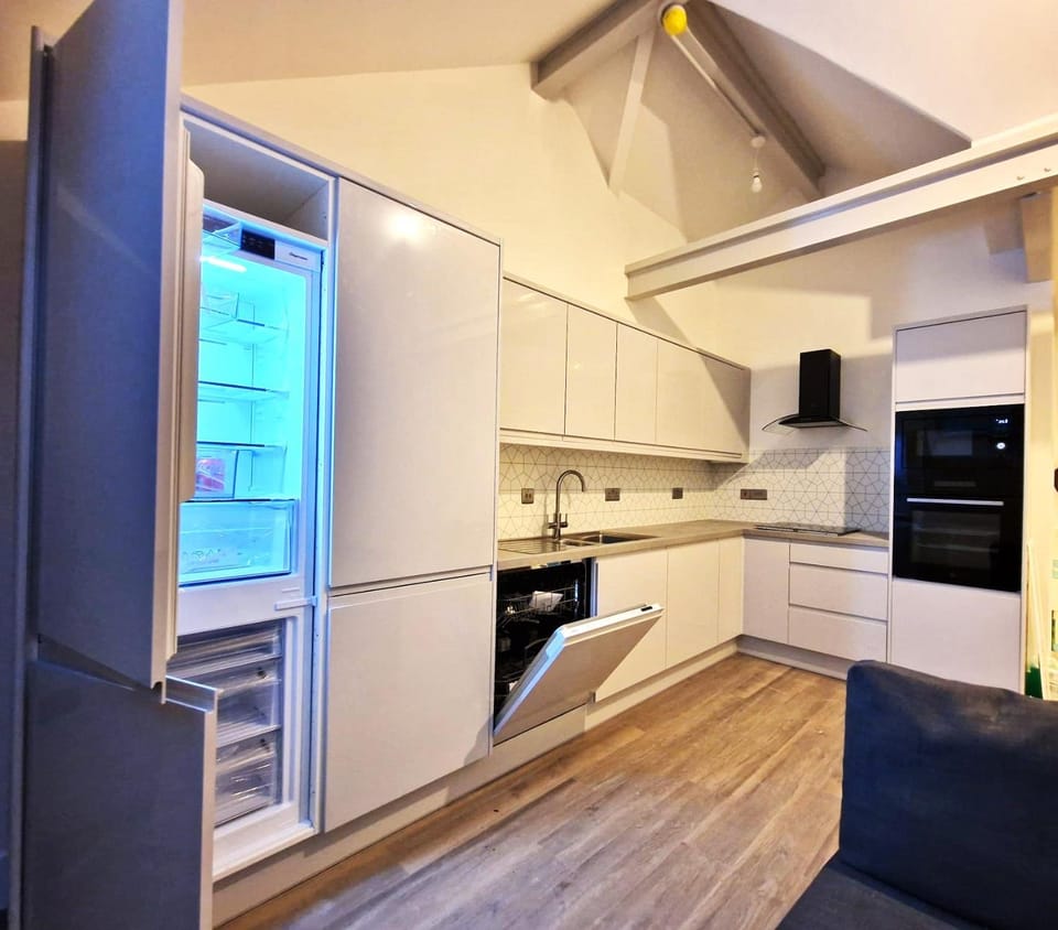 Kitchen or kitchenette, dishwasher, oven, stove