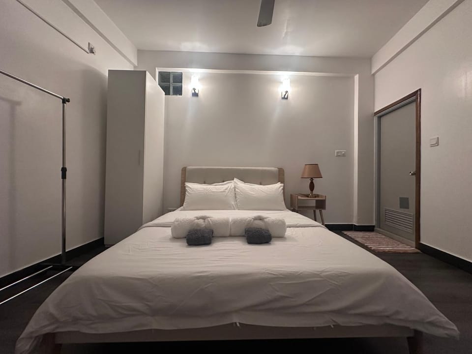 Bed, Photo of the whole room, Bedroom, hair dryier, towels, air conditioner