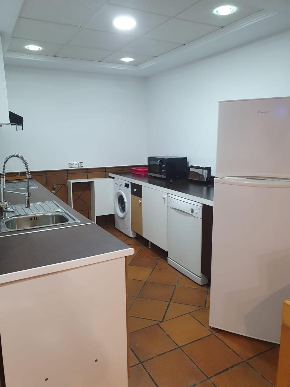 Kitchen or kitchenette, dishwasher, oven, stove