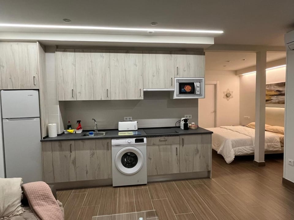 Kitchen or kitchenette, stove, toaster, washing machine
